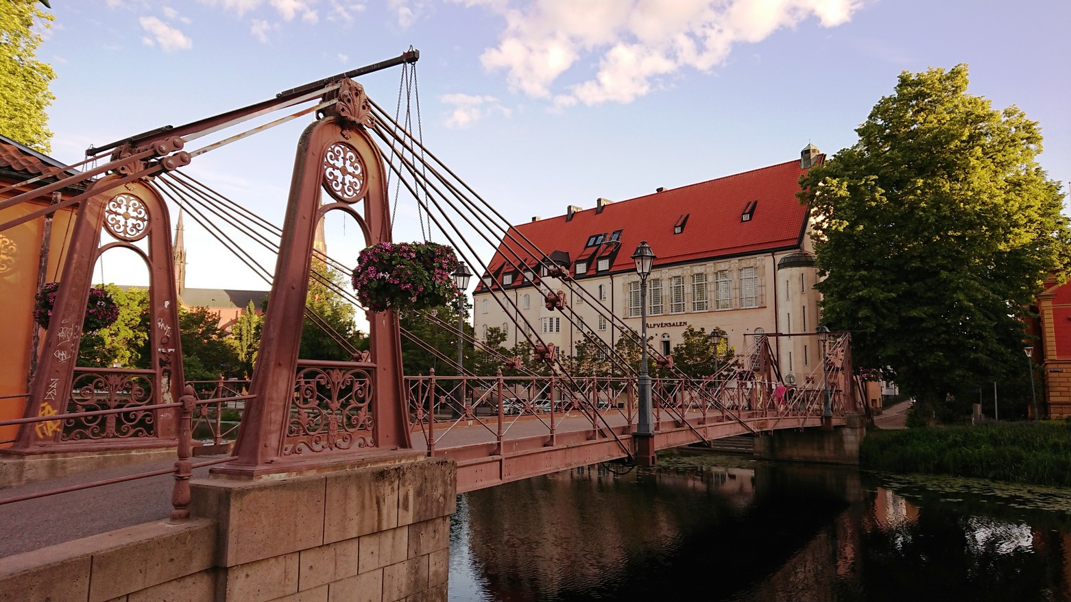 The Alfvén Hall beside the iron footbridge over the Fyris river in Uppsala