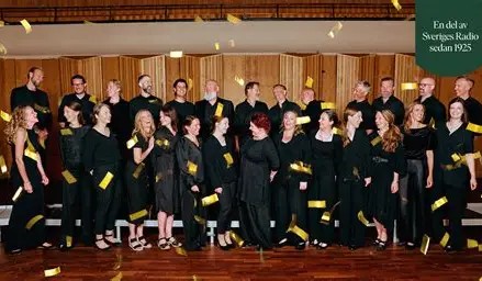 A choir on stage as golden confetti falls