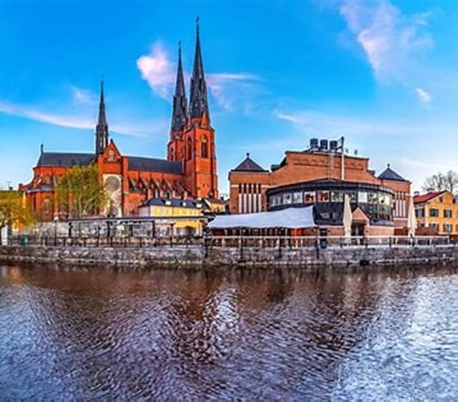 Uppsala Cathedral and the Fyris river at dusk